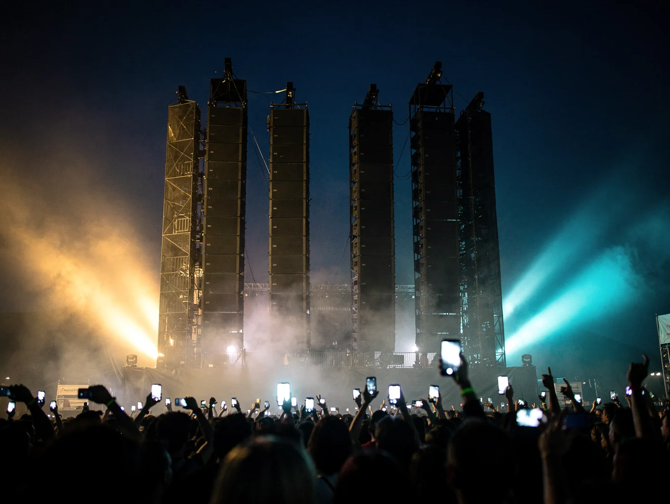 Live concert festival crowd with luminous blue stage lighting and outdoor rig