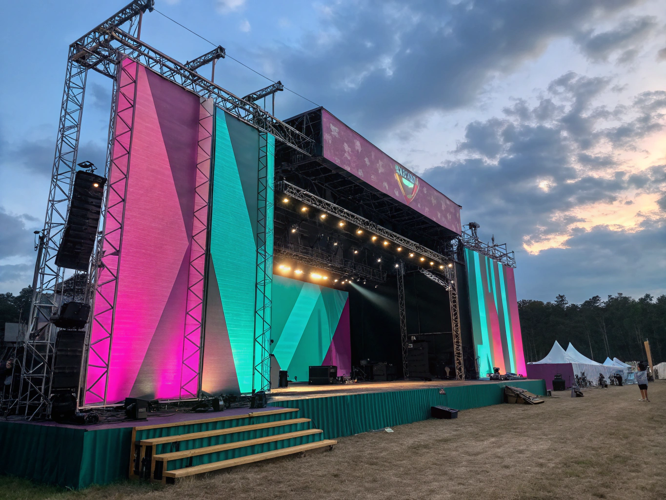 Assembled outdoor festival stage with truss roof and safety rails